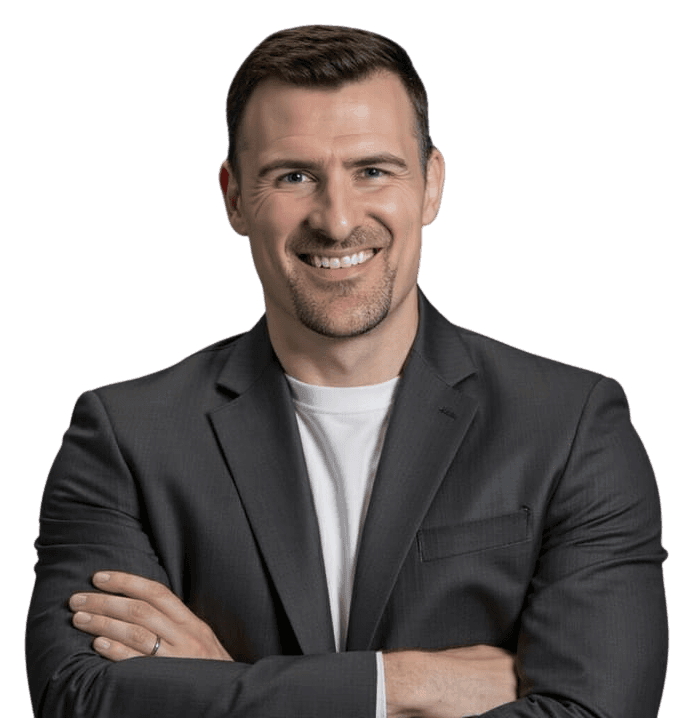 Gabe Petersen, founder of Rainier Growth Partners, smiling with arms crossed, in a charcoal blazer over a white T-shirt.